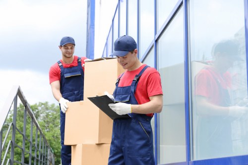 Professional movers handling furniture in a Kentish Town flat