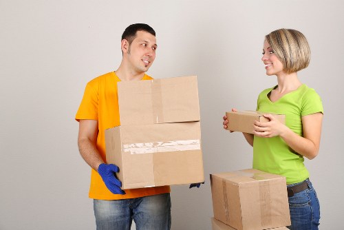 Protective wrapping and careful lifting equipment used for a piano move in Kentish Town